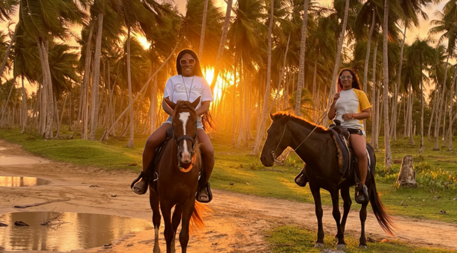 Two women horseback riding at sunset in Punta Cana's lush landscape