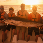 Family fishing trip in Punta Cana with a large marlin catch at sunset