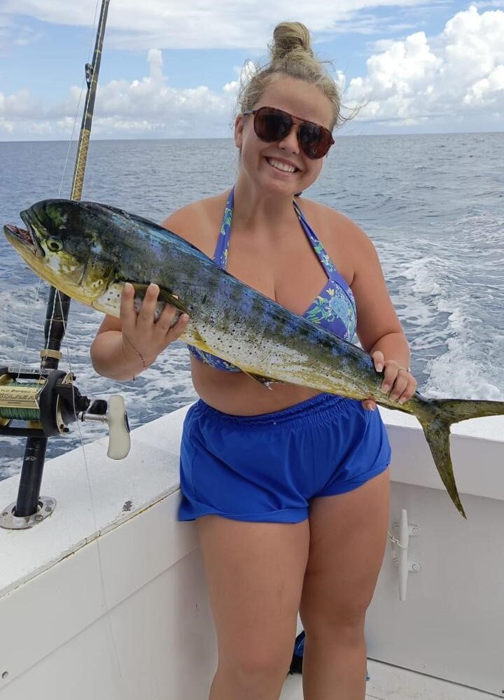 Woman holding a large fish while fishing in Punta Cana